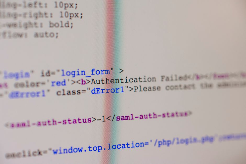 Close-up of HTML and PHP code on screen showing error message and login form data