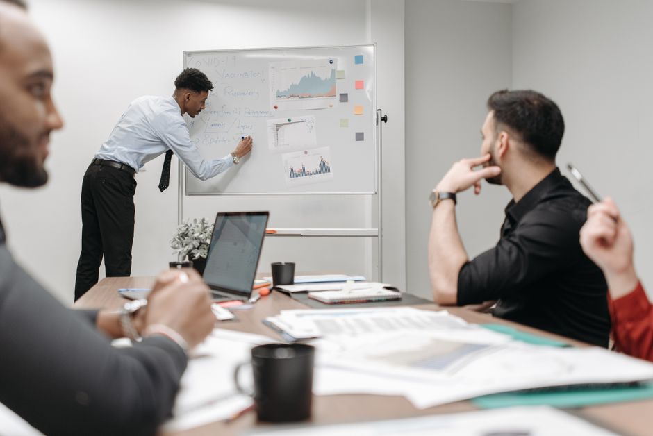 Colleagues in a business meeting discussing data and strategies at the office