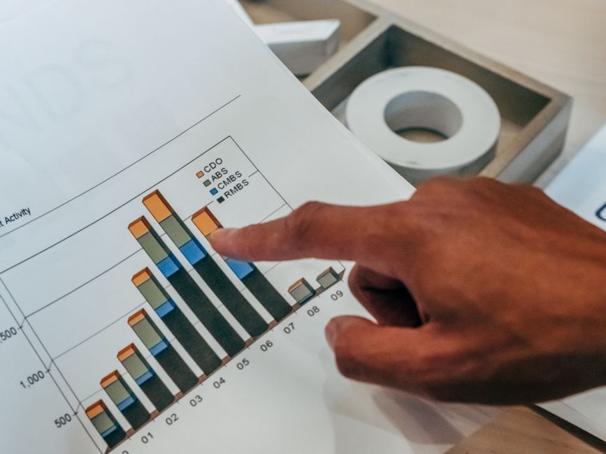 Professional analyst pointing to analytical data graphs and competitor benchmarking charts for generative search gap analysis