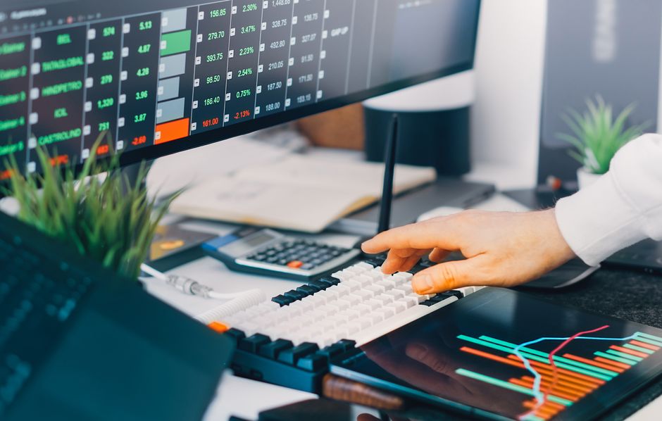 Professional workspace with revenue analytics and attribution charts on screens, representing B2B AI search pipeline attribution and referral tracking.
